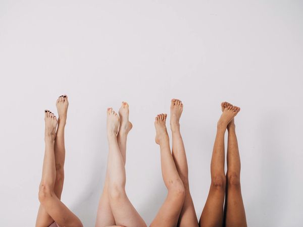 Diverse group of people smiling during a calm yoga session.
